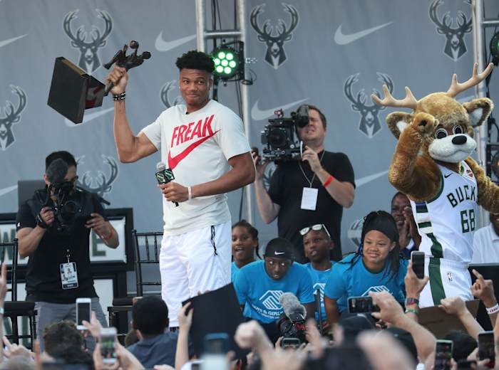 Giannis Antetokounmpo celebrates his MVP award with Bucks fans.
